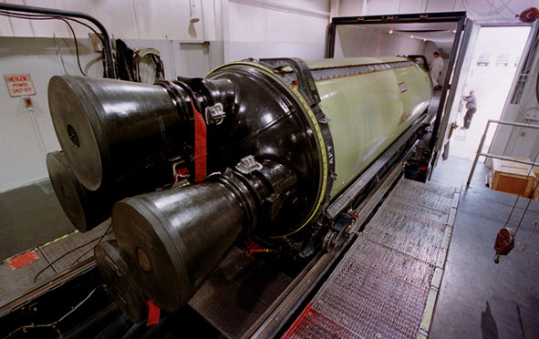 A Minuteman III missile engine being loaded into a truck.