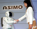 Woman shaking hands with robot