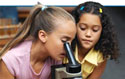Elementary school girls at a microscope