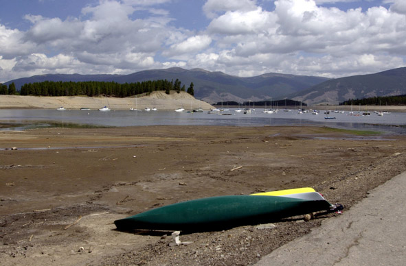 Boat overturned on dry lake bed.