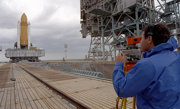 Man on launch pad sighting shuttle.
