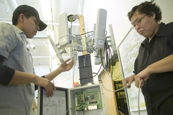 Crownpoint High School senior Rayanail Desiderio, left, and applied computers student at Navajo Technical College Alvina Lynch work on a mock up of a radio tower