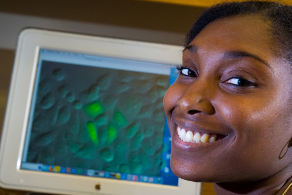 young woman in front of computer in biochem lab