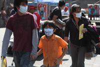 people in mexico wearing flu masks