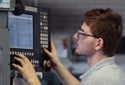 man operating computer-numerical controlled machine
