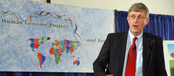 Dr. Francis Collins in front of a map of the Human Genome Project