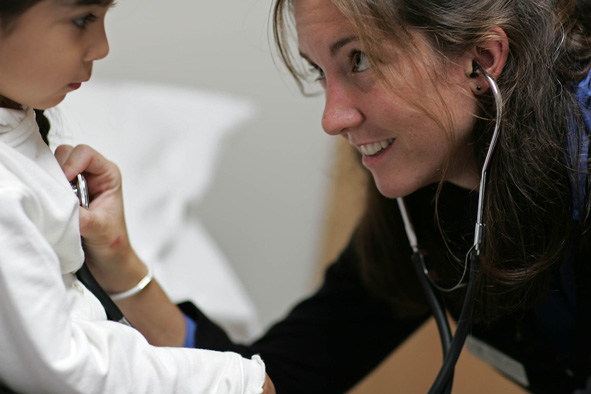 doctor listening to child's chest with stethoscope