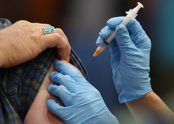 close up of medical care professional providing injection
