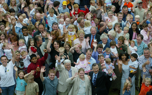 Louise Brown, front center, with Alastair Macdonald front fourth left, the first in vitro fertilized female and male babies born, attend the 25th anniversary reunion at the Bourn Hall Clinic near Cambridge, England in 2003