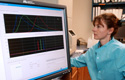 scientist working at computer in crime lab
