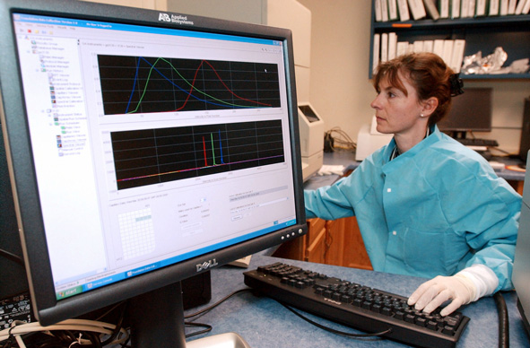 a forensic scientist runs a DNA sample on a computer at the Vermont Forensic