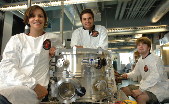 engineering students wearing white coats in lab