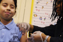 girl receiving H1N1 vaccine