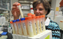 woman working in lab with test tubes