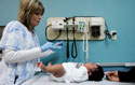 A medical assistant prepares a vaccination for a two-month-old during a wellness check at Children's Hospital in Minneapolis, Monday, Dec. 18, 2006.