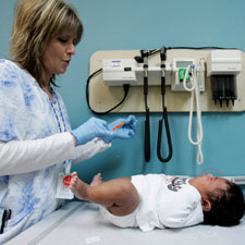 A medical assistant prepares a vaccination for a two-month-old during a wellness check at Children's Hospital in Minneapolis, Monday, Dec. 18, 2006.