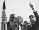 Dr. Wernher von Braun explains the Saturn Launch System to President John F. Kennedy in 1963 as NASA Deputy Administrator Robert Seamans looks on.